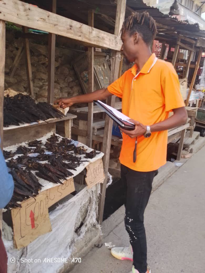 Surveyor recording cost-of-living field notes