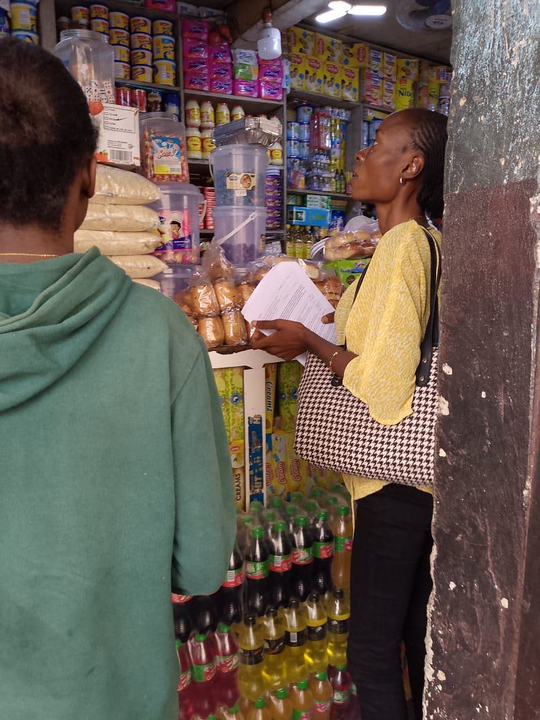 Surveyor recording retail prices in a store