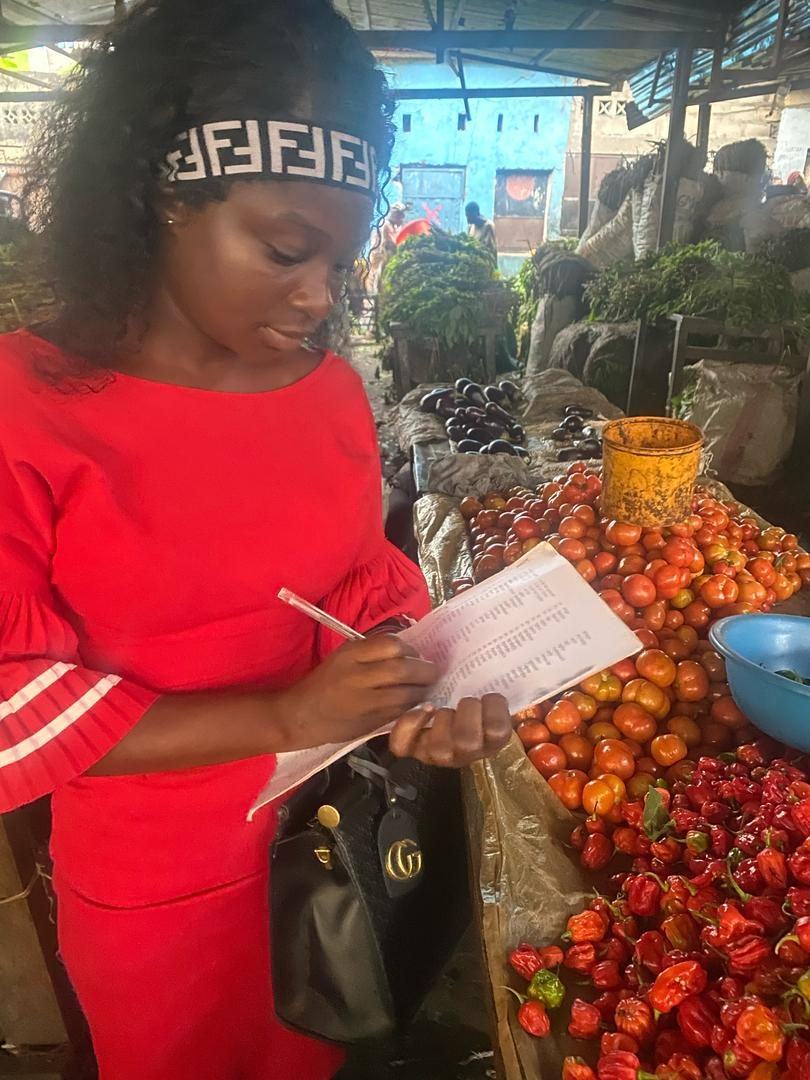 Surveyor recording produce prices at a market